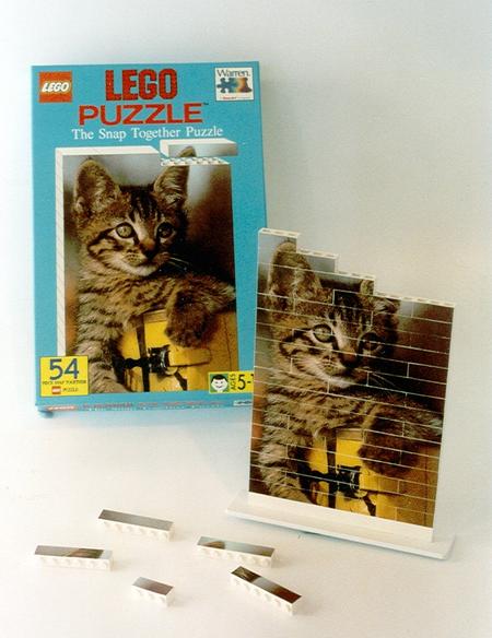A partially completed LEGO puzzle of a tiger with box and pieces.