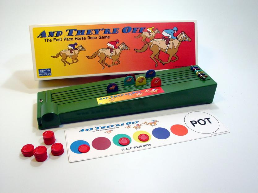 Vintage board game "Au Temps des Os" with colorful pieces and dino-themed box.