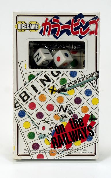 Vintage bingo game with colorful markers and dice in packaging.