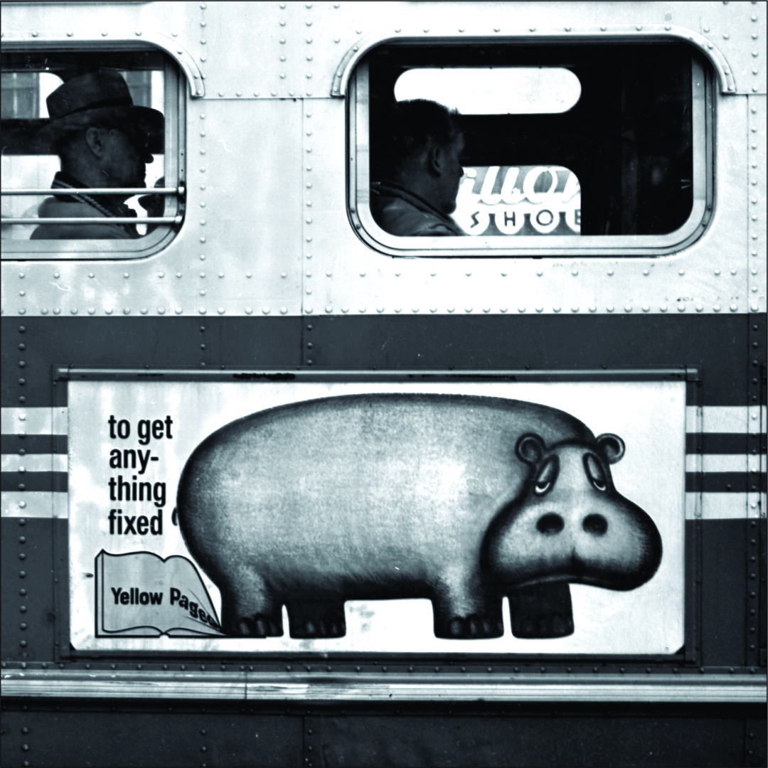 A hippo-shaped food container on a train with a sign.