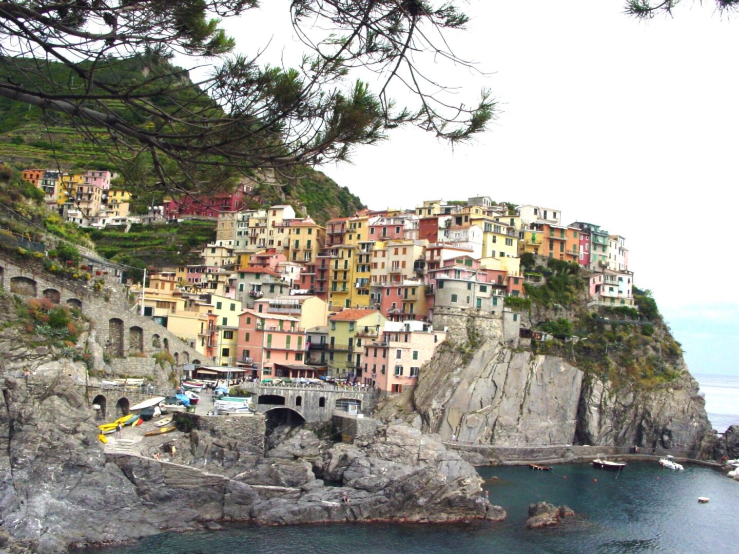 Colorful houses perched on cliffs by the sea in a coastal village.
