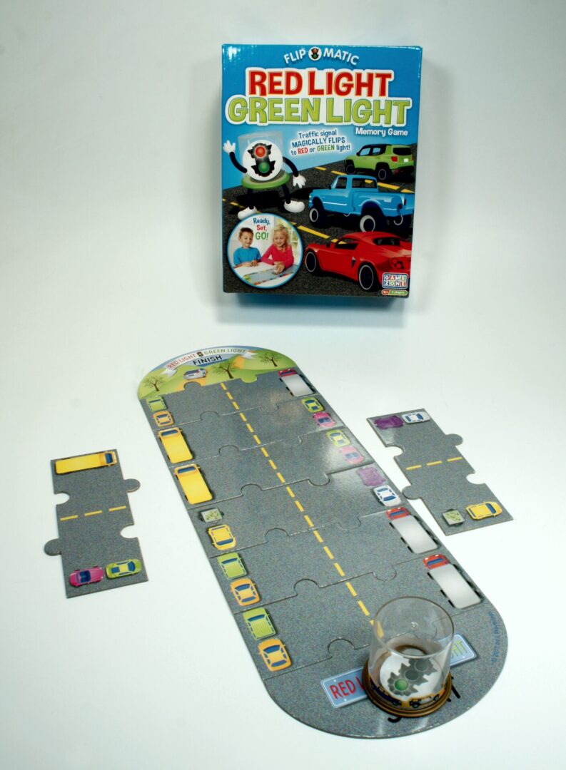 A car racing board game with a race track and cards.