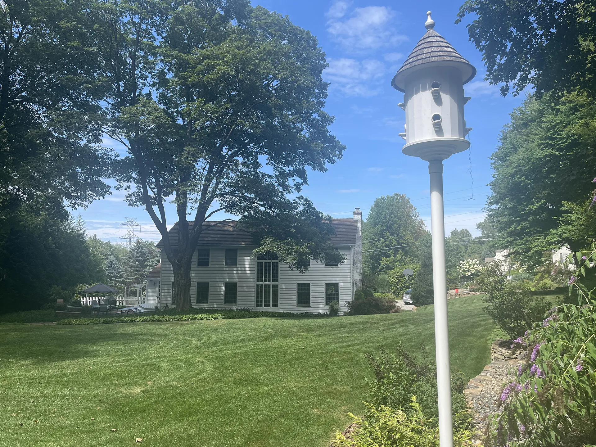 Historic house with a birdhouse on a sunny day.