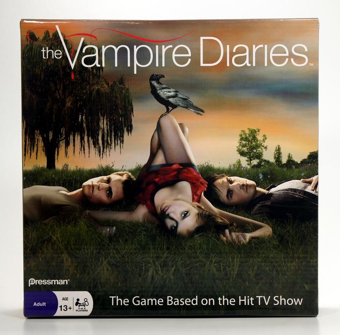 Promotional image for The Vampire Diaries game featuring a woman lying on the ground at sunset.