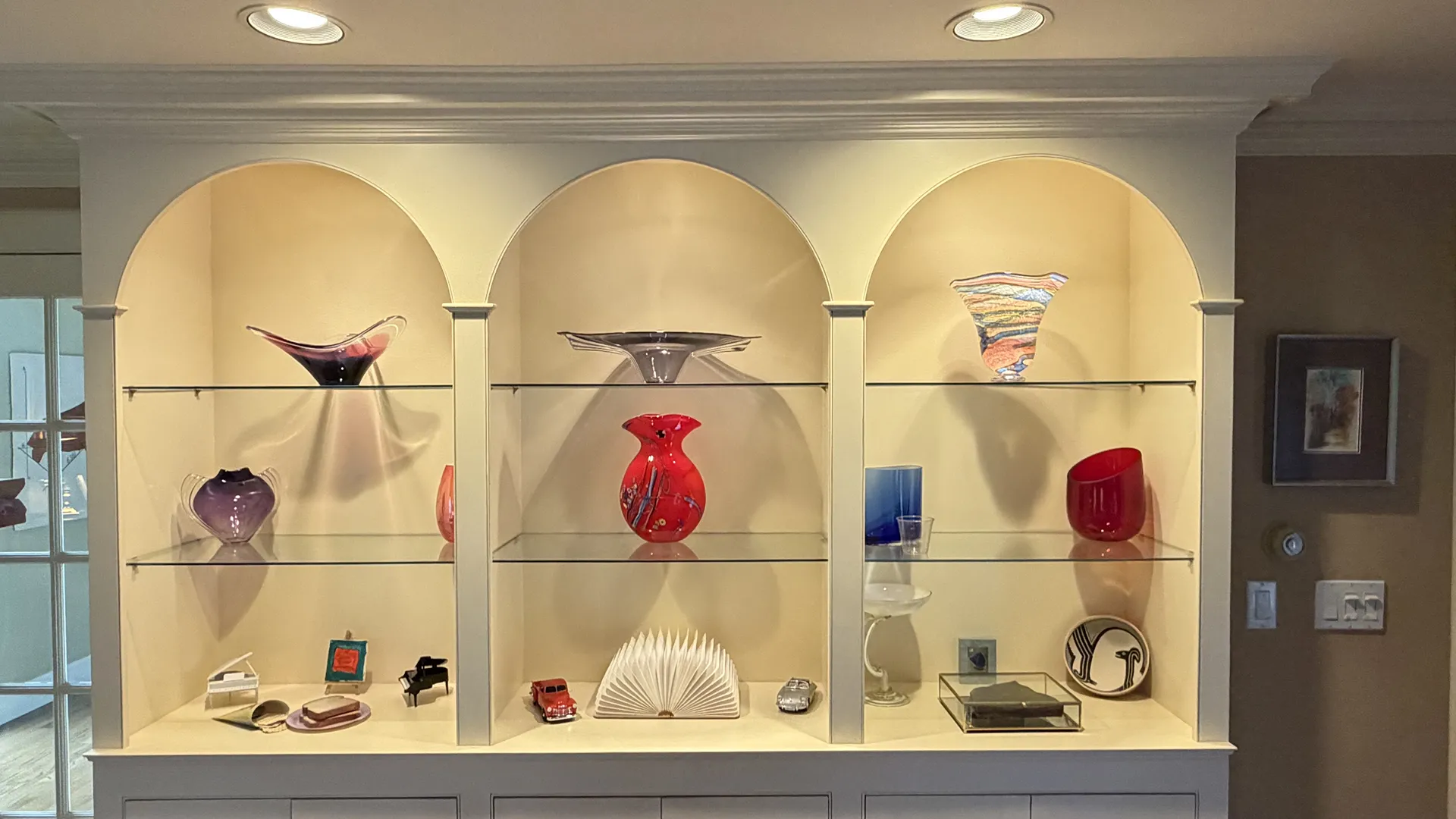 Display of intricately designed handbags and accessories in a museum-like setting.