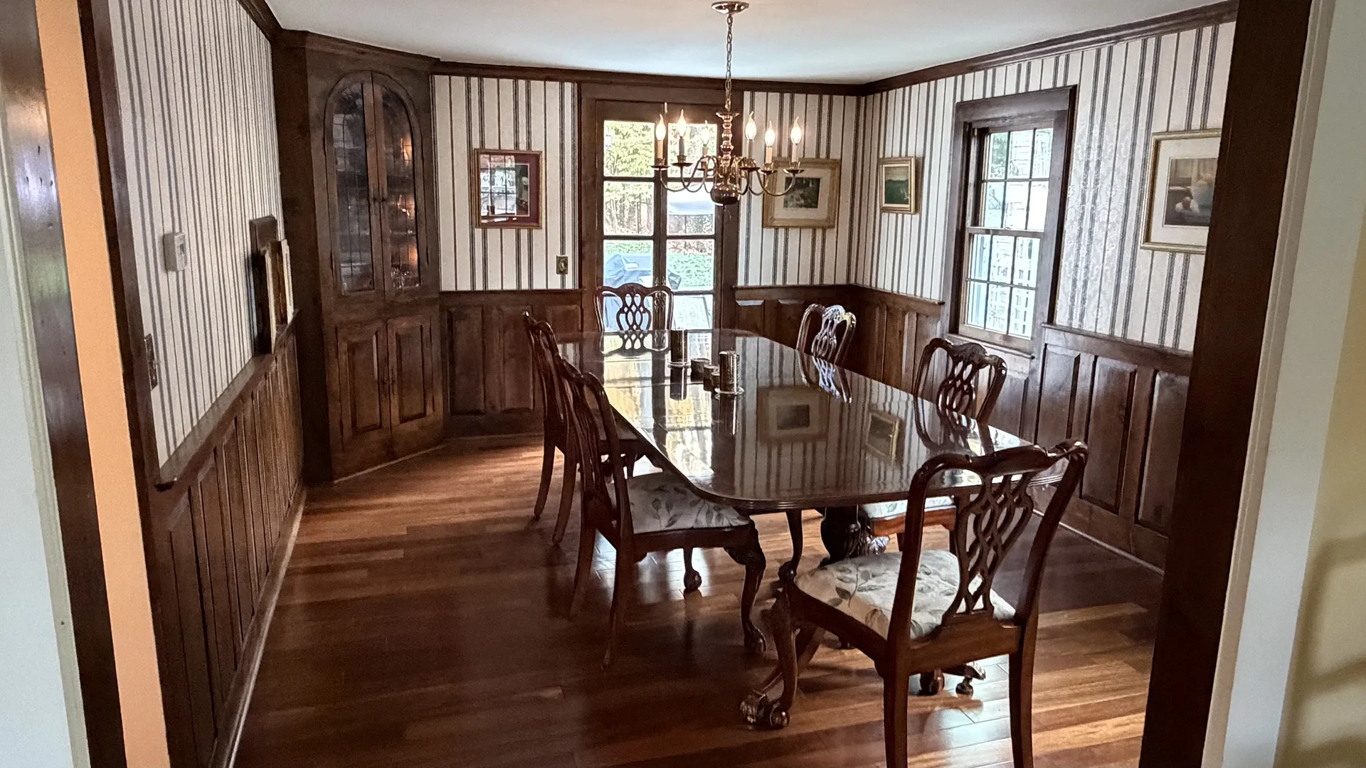 Elegant dining room with wooden furniture and natural light.
