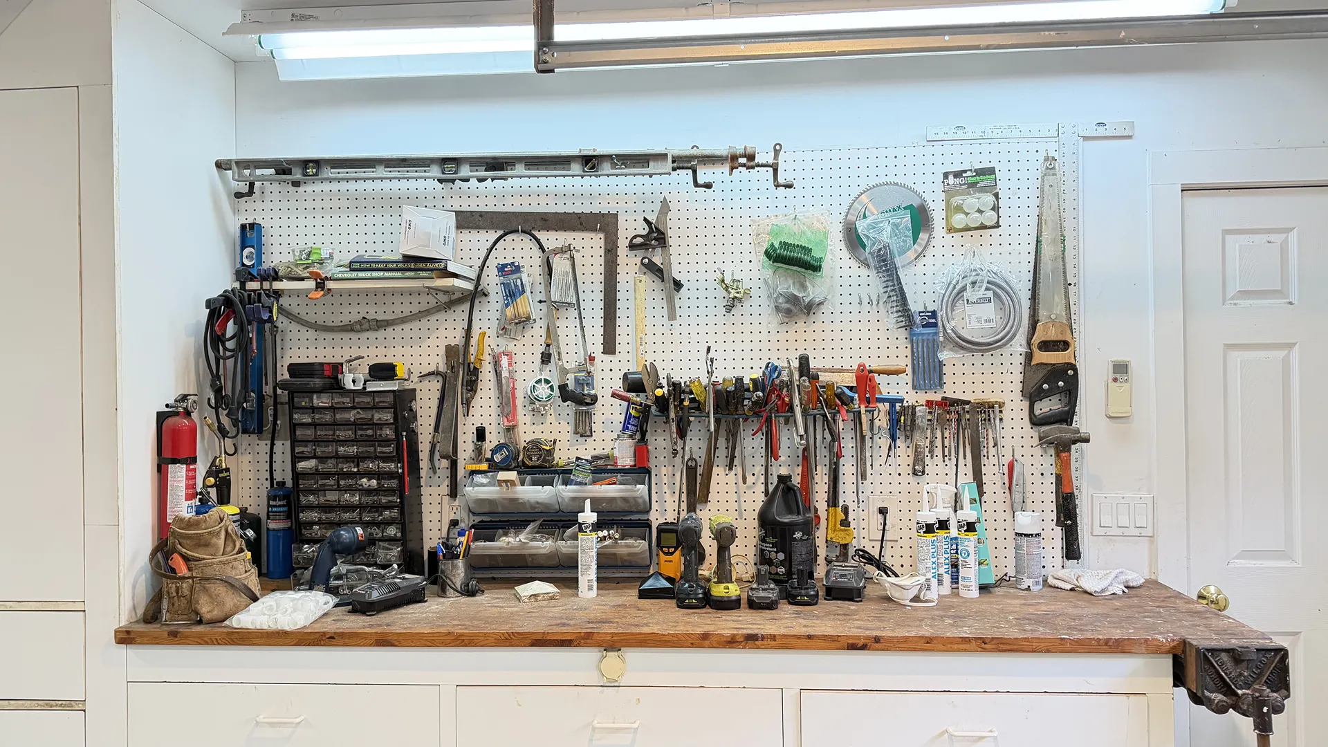 A well-organized workshop bench with various tools and equipment.