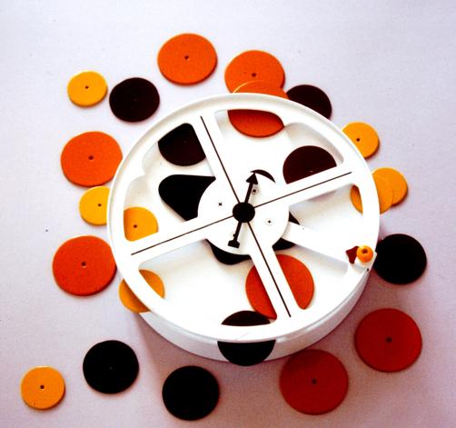 A creative clock with orange, brown, and yellow circular designs.