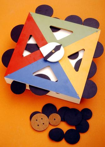 Colorful geometric puzzle pieces arranged on a surface with black buttons.