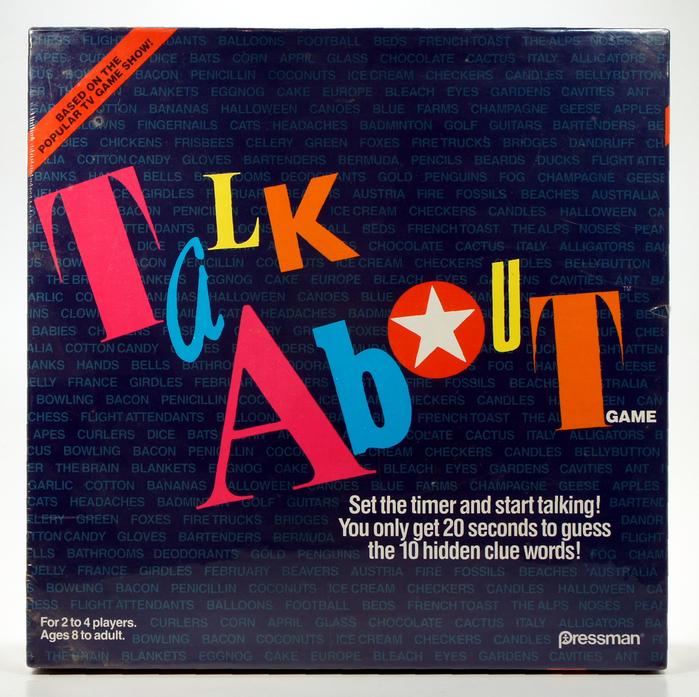 Colorful text on a dark brick wall saying 'Talk About'.