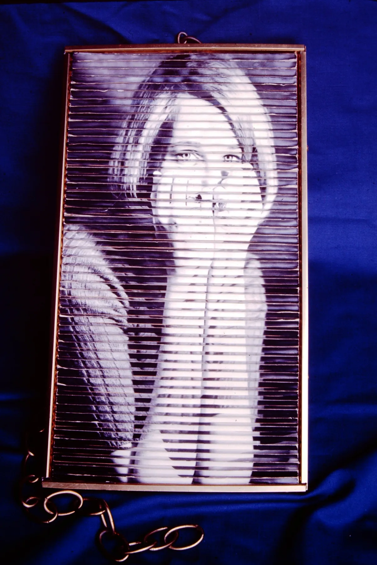 Black and white photo of a woman resting her face on her hand.