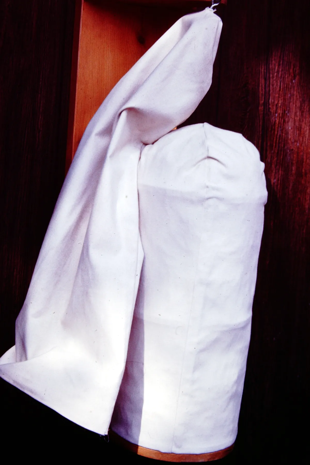White fabric draped and folded against a dark background.