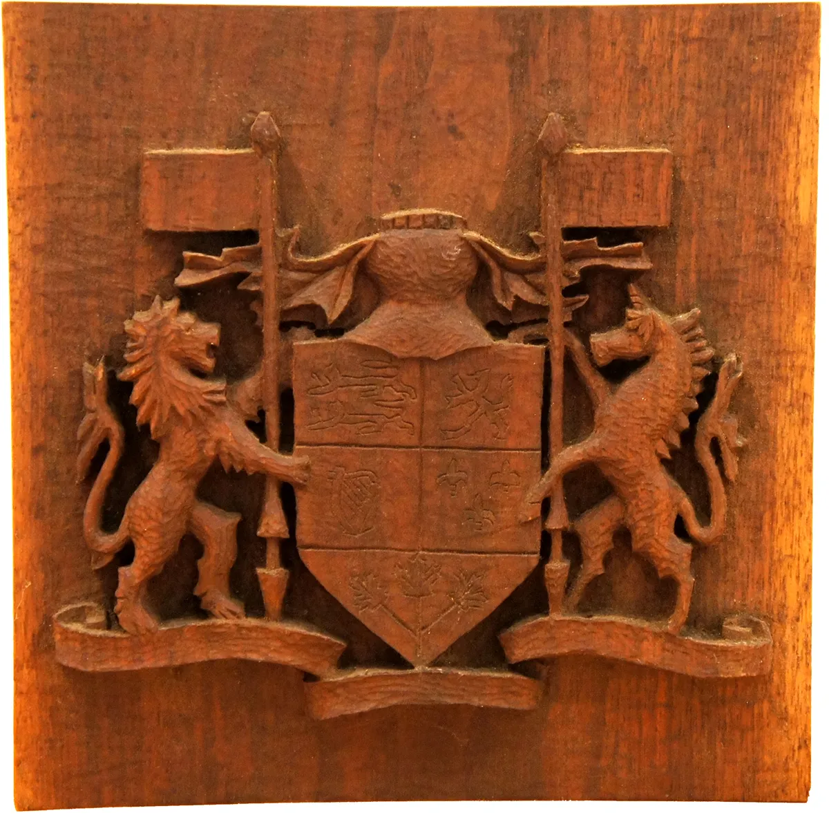 Wooden carved coat of arms featuring two lions and a shield.