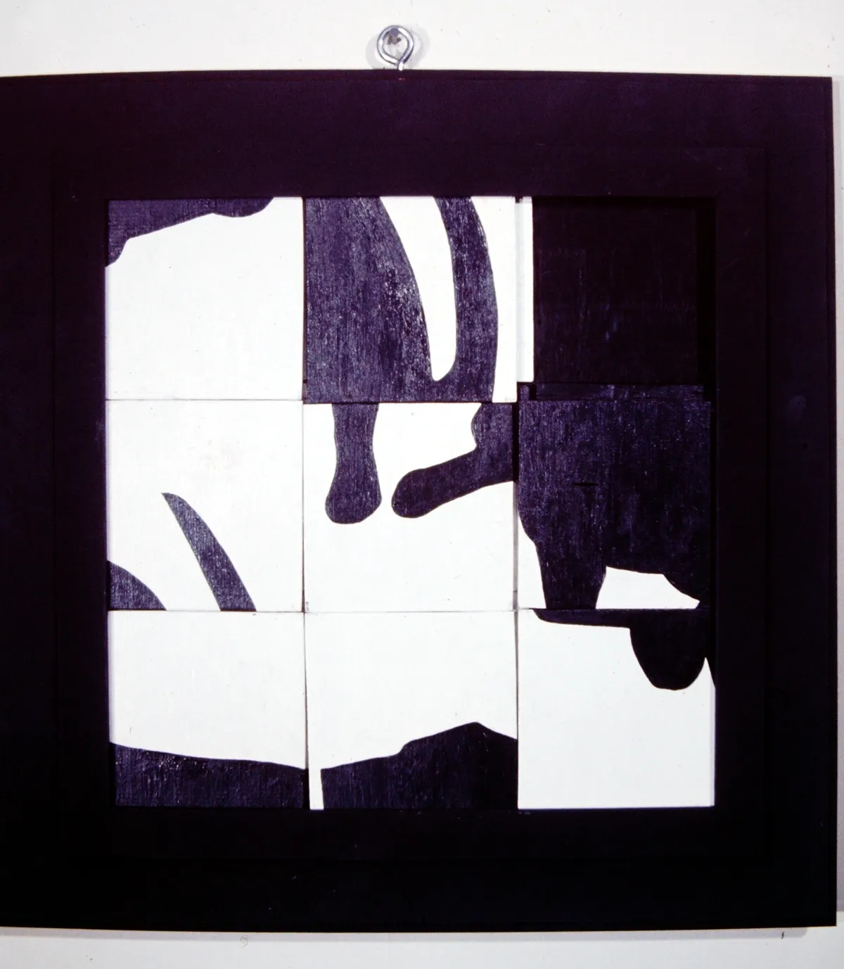 Abstract black and white geometric shapes on tiles.