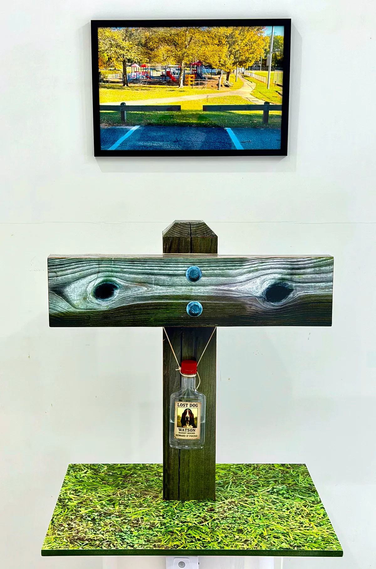 Wooden birdhouse painted with eyes and a nose-like design.