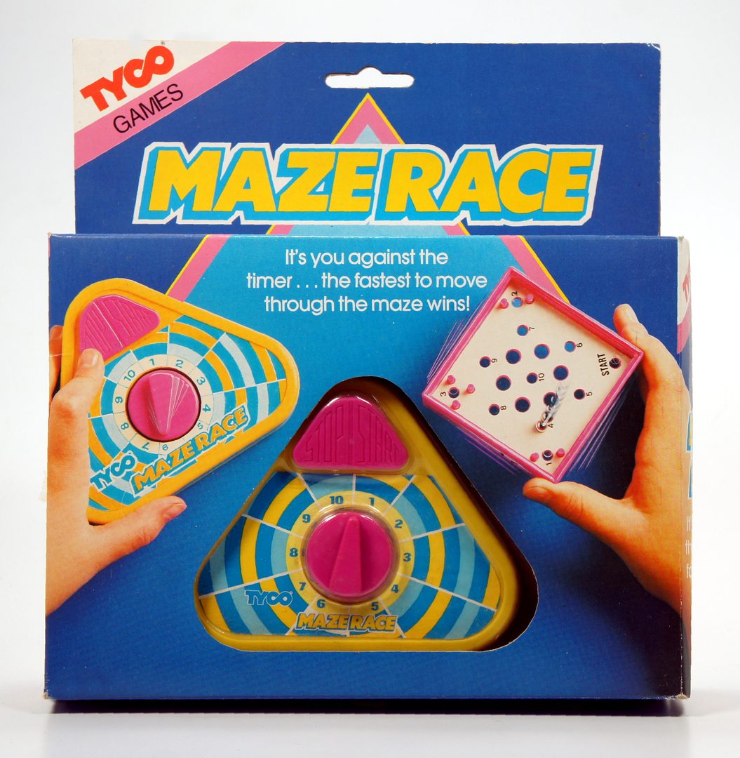 Two hands playing the vintage TYCO Maze Race game with a triangular board and colorful paths.