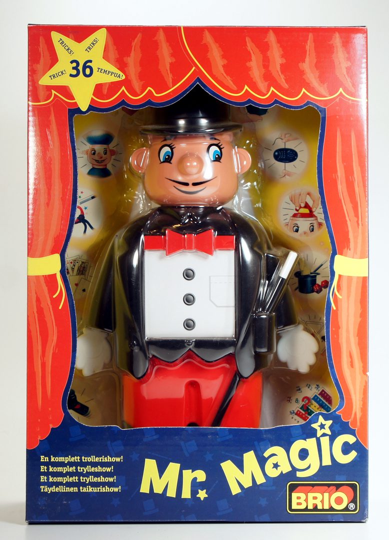 A vintage magic trick toy with a smiling magician figure in a box.