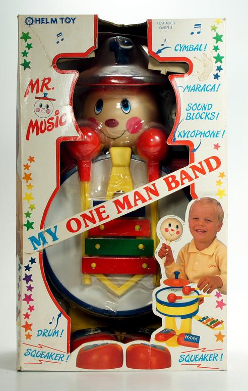 Vintage Mr. Music toy with a drummer and baby illustration.