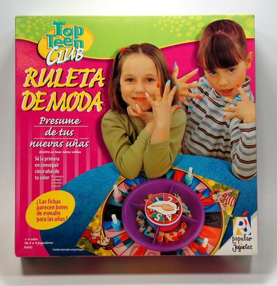 Two girls playing a colorful fashion roulette game called "Ruleta de Moda."