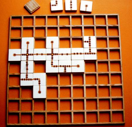 Scrabble tiles forming words on a wooden board.