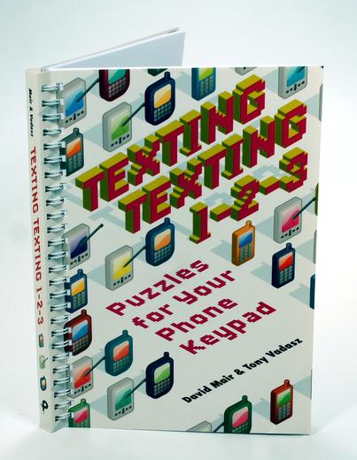 A colorful book titled "Texting Testing 0-128" about puzzles for phones and keyboards.