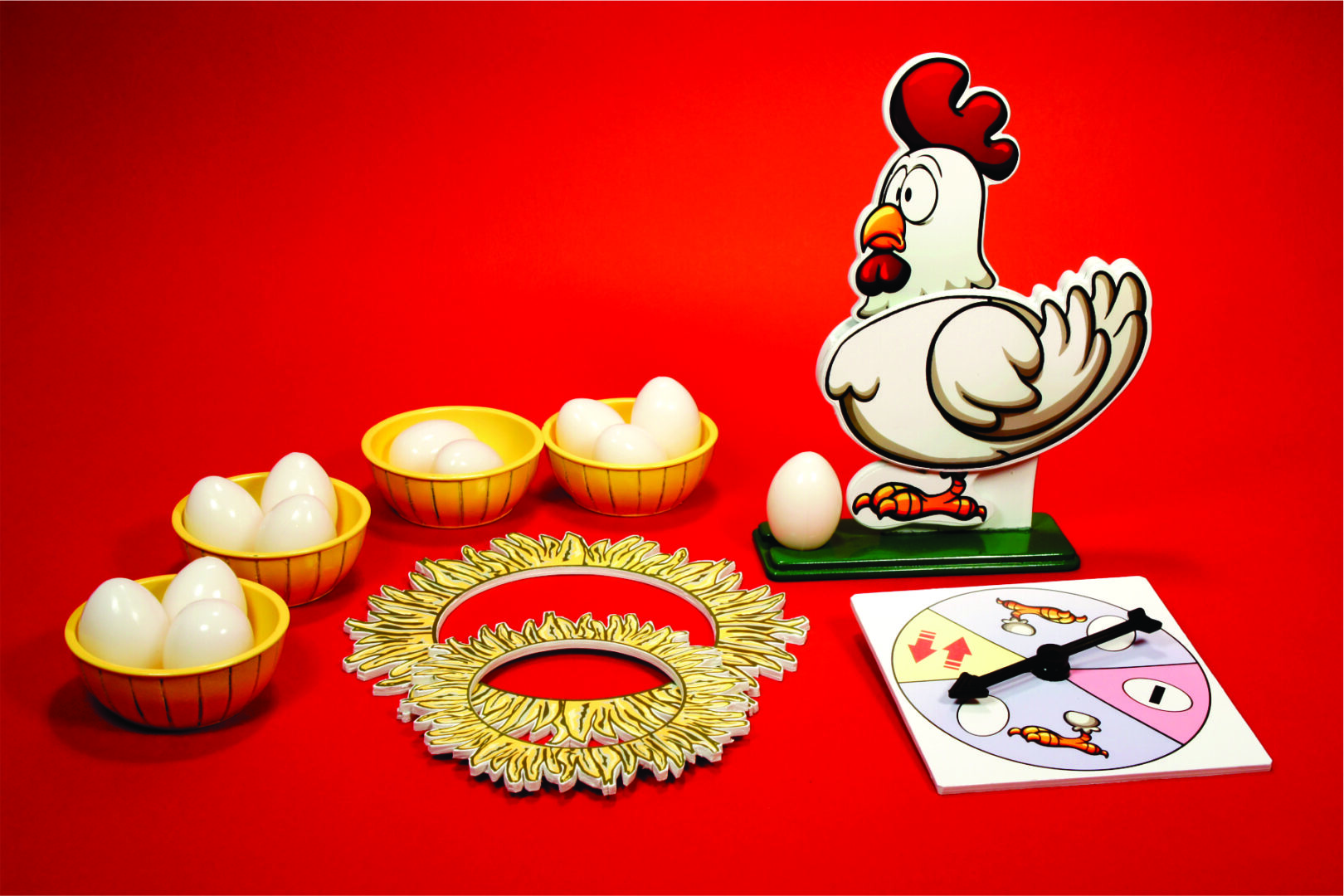 Traditional Indian wedding items including a decorative ring and a rooster figurine.