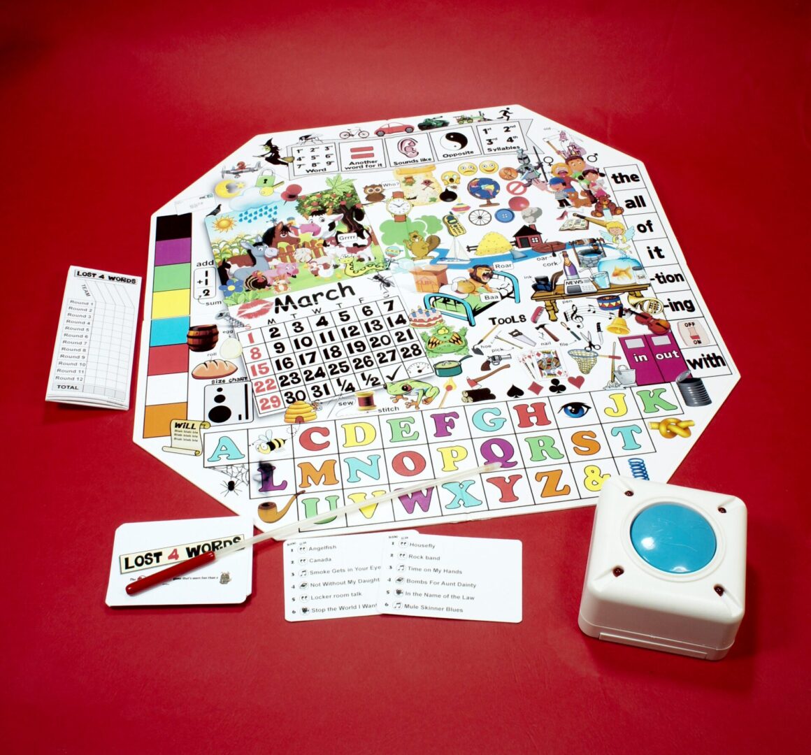 A colorful board game with cards, a die, and a spinner on a red surface.