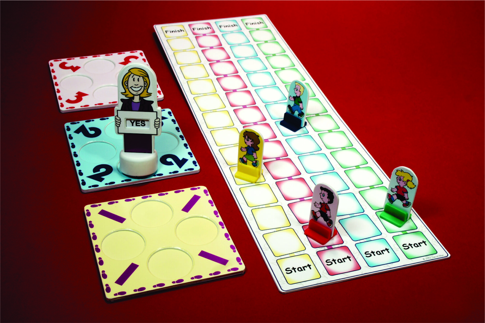 Board game pieces and cards arranged on a colorful game board.