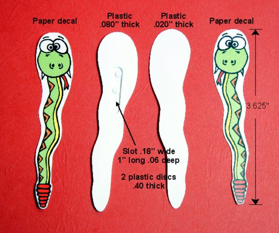 Illustration of a green worm with labeled body parts and cut-out shapes.