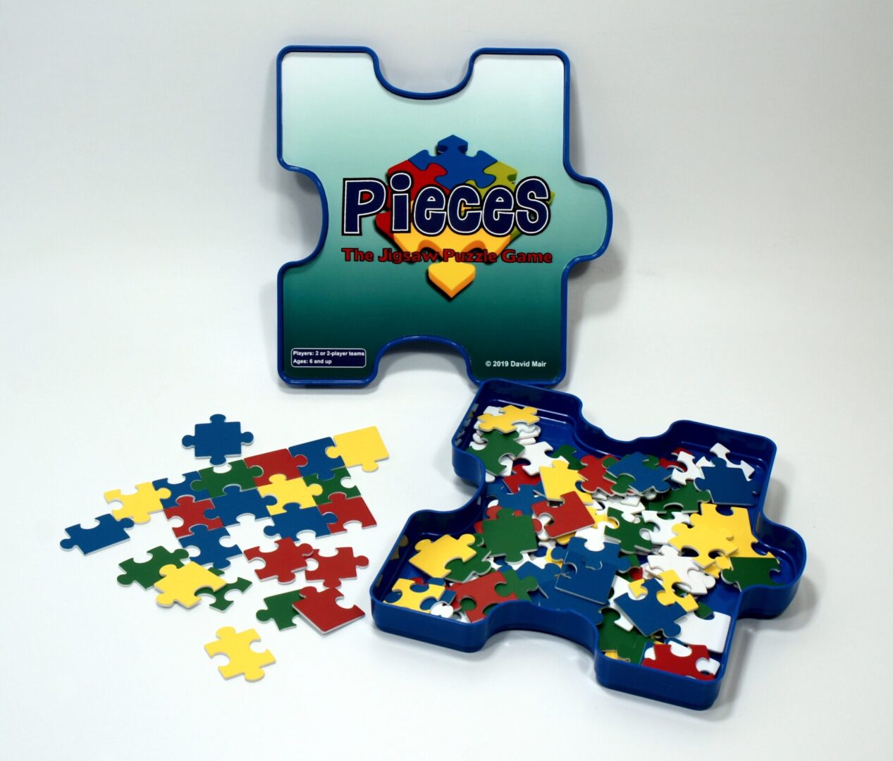 Colorful puzzle pieces spilling from a puzzle-shaped box.