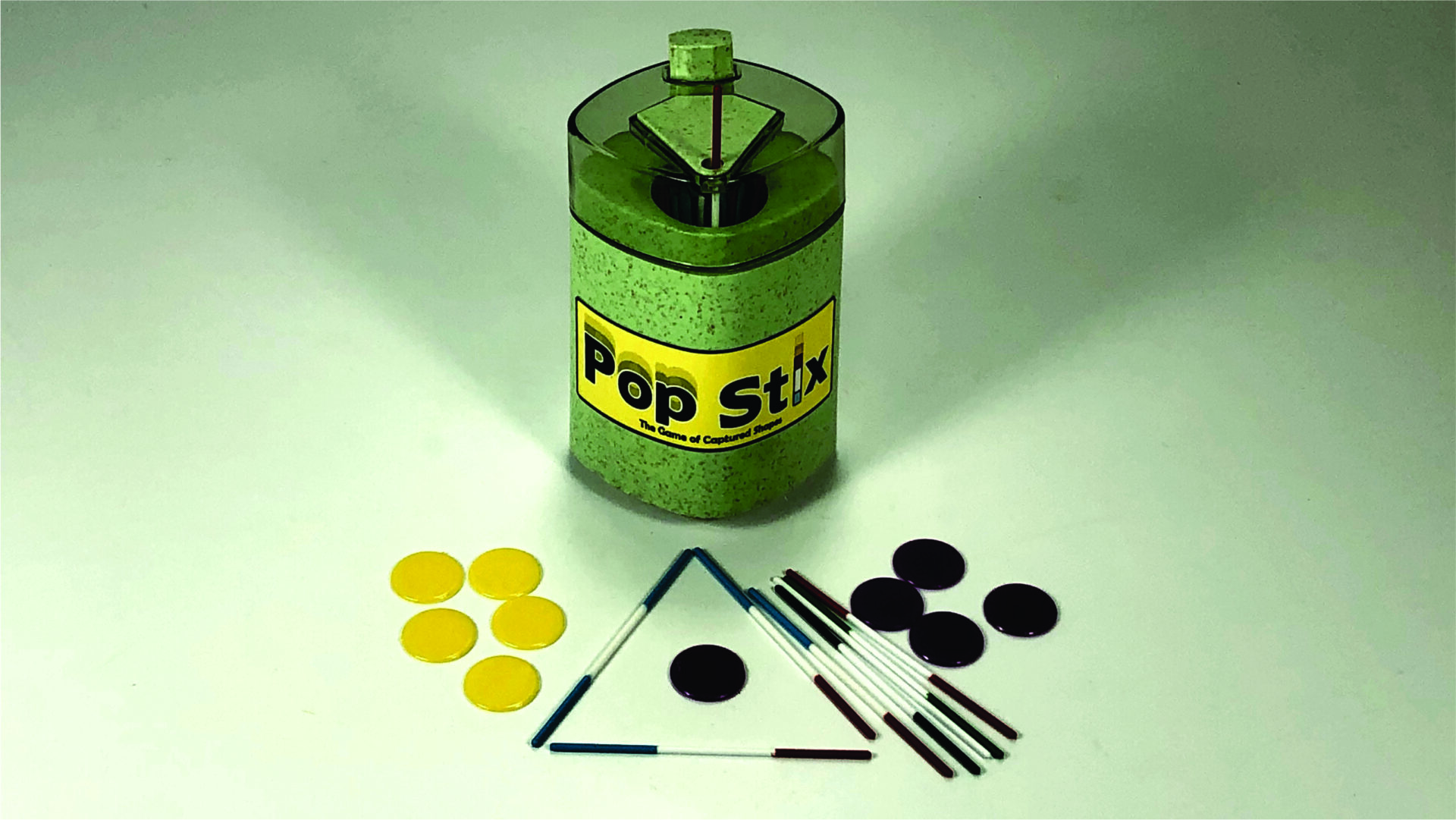 A vintage Pop Stick game with colored sticks and round tokens.