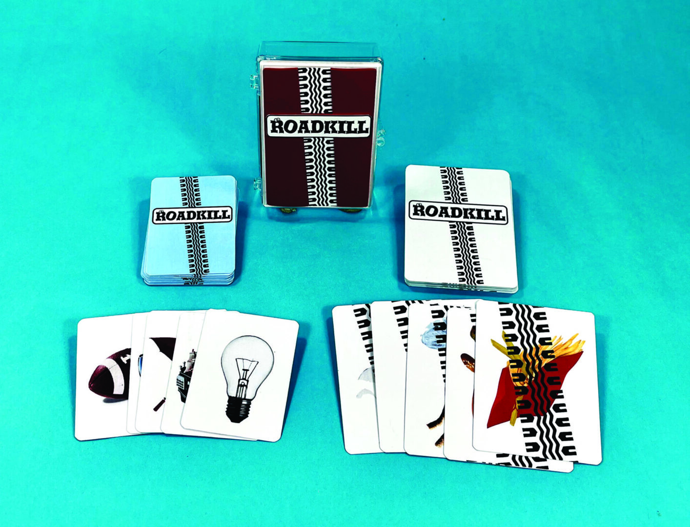 A board game set with cards, tokens, and dice on a blue surface.