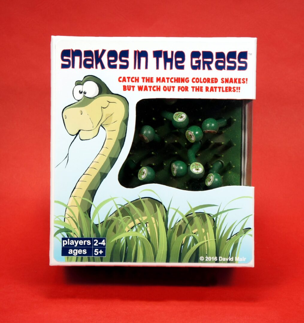 Box cover of the game 'Snakes in the Grass' with a cartoon snake illustration.