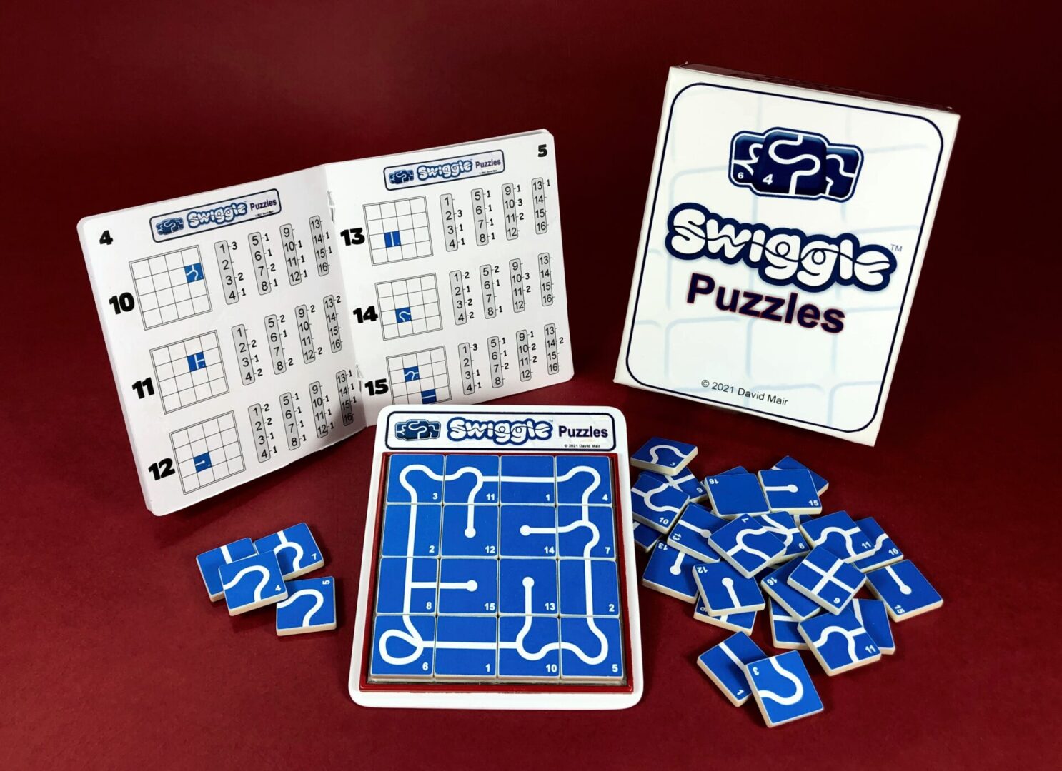 Swiggle Puzzles game with maze cards and blue puzzle pieces.