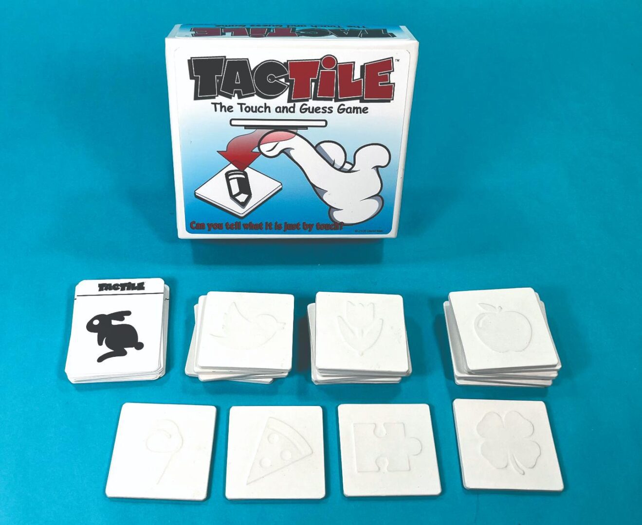 TagTile card game with illustrated cards and blue box packaging.