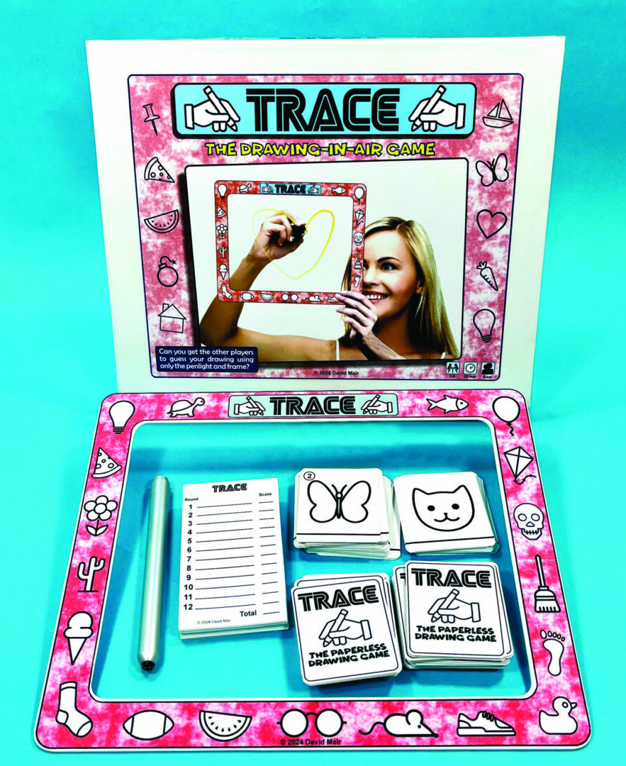 A woman plays a colorful card game called TRACE, focused on drawing and guessing.