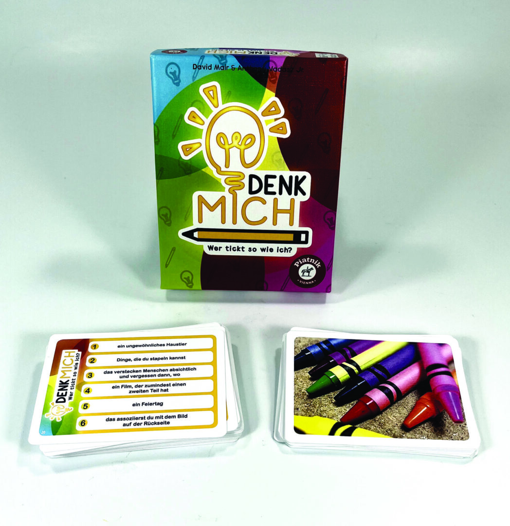 A colorful card game named "Denk Mich" with cards and markers.